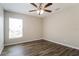 Bright bedroom with wood-look floors and a large window at 849 Haleybury St, Port Charlotte, FL 33948