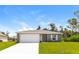 Newly constructed home with gray exterior, white garage door, and grassy lawn at 849 Haleybury St, Port Charlotte, FL 33948