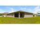 Single story home with covered patio and grassy yard at 849 Haleybury St, Port Charlotte, FL 33948