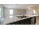 Kitchen island with double sink, white countertop, and dark brown cabinetry at 849 Haleybury St, Port Charlotte, FL 33948