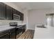Modern kitchen featuring dark brown cabinets, stainless steel appliances, and white countertops at 849 Haleybury St, Port Charlotte, FL 33948