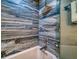 Close-up of a modern bathtub with blue patterned wall tiles at 8565 W Gulf Blvd # 17S, Treasure Island, FL 33706