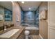 Modern bathroom boasting a stylish tub and blue marble-look tile at 8565 W Gulf Blvd # 17S, Treasure Island, FL 33706