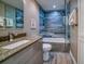 Updated bathroom with a walk-in shower and blue tile at 8565 W Gulf Blvd # 17S, Treasure Island, FL 33706