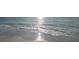 Soft sand meets gentle waves under the bright sun at 8565 W Gulf Blvd # 17S, Treasure Island, FL 33706