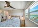 Main bedroom with water views and a ceiling fan at 8565 W Gulf Blvd # 17S, Treasure Island, FL 33706
