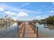 Wooden dock extends over calm water, offering waterfront access at 8565 W Gulf Blvd # 17S, Treasure Island, FL 33706