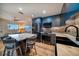 Modern kitchen with blue cabinets, marble island, and stainless steel appliances at 8565 W Gulf Blvd # 17S, Treasure Island, FL 33706