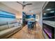 Open living room features a kitchen with blue cabinets and a modern fireplace at 8565 W Gulf Blvd # 17S, Treasure Island, FL 33706