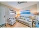 Relaxing living area featuring a comfy couch and an inviting atmosphere at 8565 W Gulf Blvd # 17S, Treasure Island, FL 33706