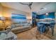 Light and airy living room with a comfortable couch and blue kitchen at 8565 W Gulf Blvd # 17S, Treasure Island, FL 33706