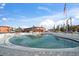 Kidney-shaped pool with surrounding patio furniture at 8565 W Gulf Blvd # 17S, Treasure Island, FL 33706