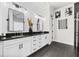 Double vanity bathroom with dark countertop and white cabinets at 8621 Ivy Stark Blvd, Wesley Chapel, FL 33545
