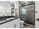 Modern bathroom with a large walk-in shower and dark vanity at 8621 Ivy Stark Blvd, Wesley Chapel, FL 33545