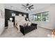 Spacious primary bedroom with large window, plush carpet, and stylish furnishings at 8621 Ivy Stark Blvd, Wesley Chapel, FL 33545