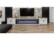 Modern fireplace with a marble accent wall and built-in shelving at 8621 Ivy Stark Blvd, Wesley Chapel, FL 33545