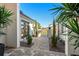 Modern front entry with paver walkway and gated courtyard at 8621 Ivy Stark Blvd, Wesley Chapel, FL 33545