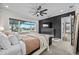 Main bedroom with fireplace, water view, and dark accent wall at 8621 Ivy Stark Blvd, Wesley Chapel, FL 33545