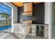 Luxury outdoor kitchen with stainless steel appliances and stone finishes at 8621 Ivy Stark Blvd, Wesley Chapel, FL 33545