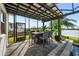 Covered patio with seating area and fire pit, overlooking the pool at 8621 Ivy Stark Blvd, Wesley Chapel, FL 33545