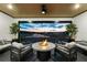Cozy patio with fire pit and comfortable seating overlooking the lake at 8621 Ivy Stark Blvd, Wesley Chapel, FL 33545