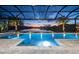 Relaxing pool with a covered patio and lake view at 8621 Ivy Stark Blvd, Wesley Chapel, FL 33545