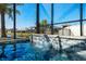 Relaxing pool with a waterfall feature and screened enclosure at 8621 Ivy Stark Blvd, Wesley Chapel, FL 33545