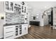 Modern wet bar with white cabinets, stone backsplash, and wine storage at 8621 Ivy Stark Blvd, Wesley Chapel, FL 33545