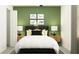 bedroom with dinosaur art and green accent wall at 9404 Runaway Breeze Dr, Land O Lakes, FL 34637
