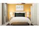 Bedroom with mustard yellow walls and a cozy bed at 9404 Runaway Breeze Dr, Land O Lakes, FL 34637