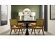 Home office with a desk, two chairs, and green accent wall at 9404 Runaway Breeze Dr, Land O Lakes, FL 34637