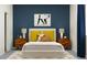 Bedroom with wood nightstands and yellow pillows at 9706 Minnow Ray Dr, Land O Lakes, FL 34638