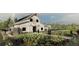 White farmhouse with large doors, surrounded by garden and farmland at 9706 Minnow Ray Dr, Land O Lakes, FL 34638