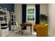 Home office with yellow chairs and wood desk at 9706 Minnow Ray Dr, Land O Lakes, FL 34638