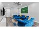 Spacious living room featuring blue velvet sofas and modern decor at 111 S Melville Ave # 4, Tampa, FL 33606