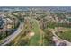 Aerial view of golf course with a sand trap and trees at 113 Woodlake Wynde # 19, Oldsmar, FL 34677