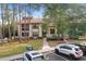 Condo building with parking and surrounding trees at 113 Woodlake Wynde # 19, Oldsmar, FL 34677