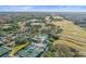 Aerial view of community pool, tennis courts, and clubhouse at 113 Woodlake Wynde # 19, Oldsmar, FL 34677