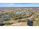 Community overview with lake, tennis courts, and homes at 113 Woodlake Wynde # 19, Oldsmar, FL 34677
