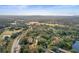 Aerial view of community near golf course and body of water at 113 Woodlake Wynde # 19, Oldsmar, FL 34677