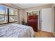 Bedroom with a queen-size bed, large window, and ample closet space at 113 Woodlake Wynde # 19, Oldsmar, FL 34677