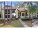 Condo building with walkway and landscaping at 113 Woodlake Wynde # 19, Oldsmar, FL 34677