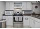 Bright kitchen features stainless steel appliances and ample cabinetry at 113 Woodlake Wynde # 19, Oldsmar, FL 34677