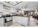 Open kitchen with stainless steel appliances and view into living area at 113 Woodlake Wynde # 19, Oldsmar, FL 34677