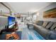 Open living room and kitchen with gray sectional sofa at 113 Woodlake Wynde # 19, Oldsmar, FL 34677