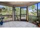 Spacious screened porch with tiled flooring and access to private yard at 113 Woodlake Wynde # 19, Oldsmar, FL 34677
