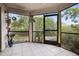 Relaxing screened porch with tiled flooring and access to backyard at 113 Woodlake Wynde # 19, Oldsmar, FL 34677