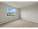 Simple bedroom with carpeted floors and a large window at 11482 Boundless Ter, Venice, FL 34293