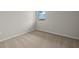 Simple bedroom with carpeted floor and a window at 11482 Boundless Ter, Venice, FL 34293