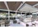 Outdoor clubhouse with a bar, comfortable seating, and fire pit at 11482 Boundless Ter, Venice, FL 34293